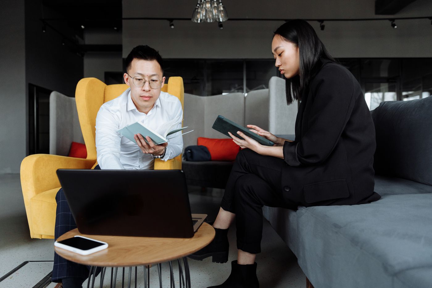 Two colleagues discussing work on a laptop